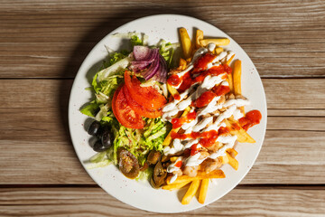  Concept of junk food and eating outdoor. Man cooking traditional wraps shawarma street food 