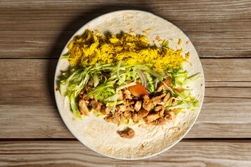  Concept of junk food and eating outdoor. Man cooking traditional wraps shawarma street food 