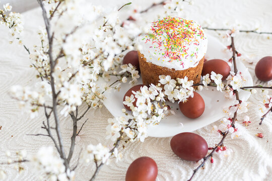 Traditional Easter cakes and colored eggs. A branch tree