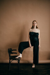 Fototapeta premium red-haired girl and black vintage chair