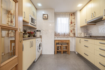A conventional kitchen with cream-colored cabinets