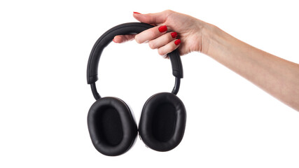 Fototapeta na wymiar Woman's hand holding large black headphones isolated on white background