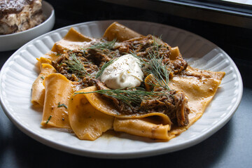 Slowly Braised Lamb Ragu on a white plate