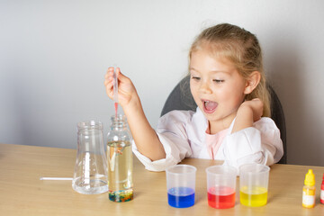 Little girl doing a science experiment. Kindergarten. Education concept