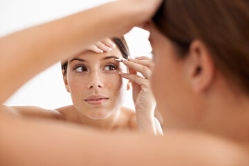 Beauty, mirror reflection and woman face for eyebrow maintenance, hair removal or cosmetic routine....
