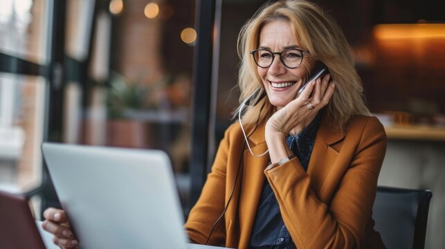 Happy Smiling Mature Middle Aged Business Woman, 40s Professional Lady Executive Manager Talking On The Cell Phone Making Business Call On Cellphone At Work In Office