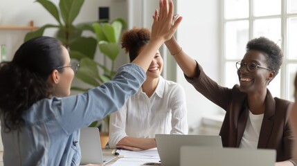 Happy young woman worker giving male colleague high five celebrating good team work results,...