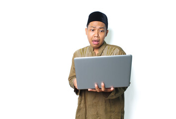 shocked asian muslim man holding laptop looks scared isolated on white background