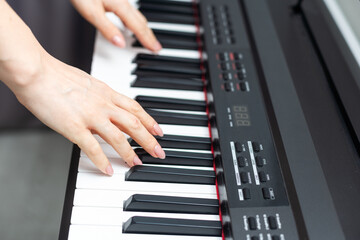 keyboard and hands playing the piano