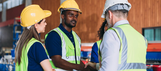 Team engineers and foreman stack hand and shake hands to show success at factory machines. Worker industry join hand for collaboration.