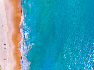 Aerial view of Waves crashing on sandy shore,Sea surface ocean waves background,Top view beach background