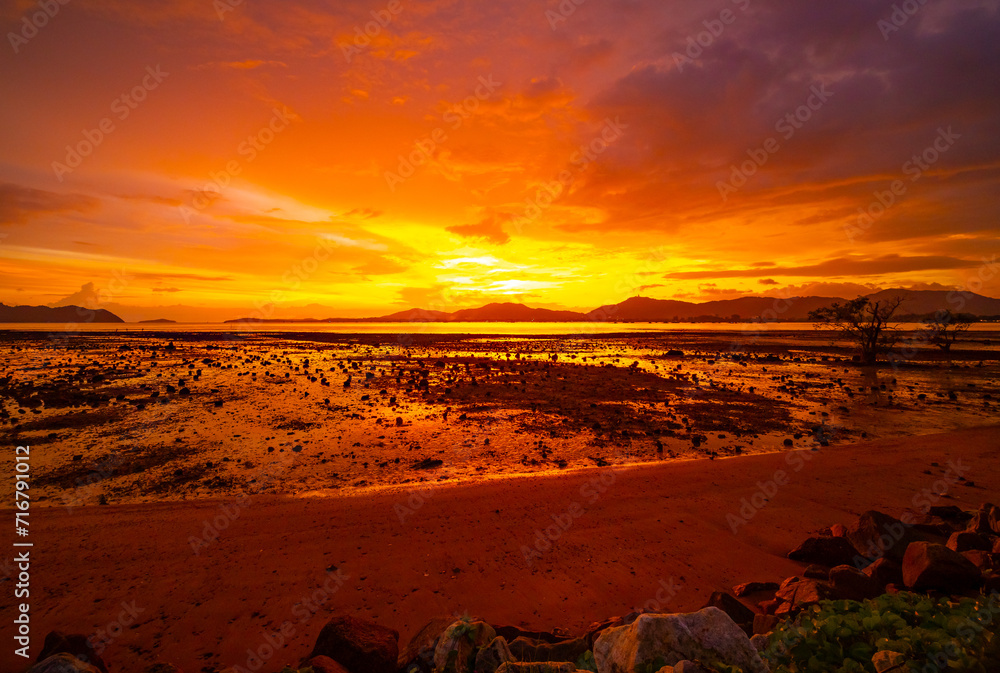 Wall mural Beautiful colorful sunset or sunrise sky over sea with dramatic clouds nature environment background