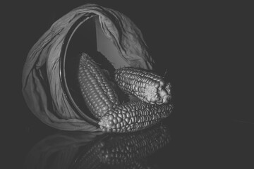 some old corn or dry corn in the basket, corn in a basket in a low light place