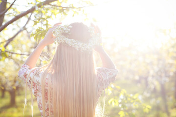 Beautiful romantic woman with long blond hair in a wreath - obrazy, fototapety, plakaty