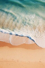 Fototapeta na wymiar Aerial shot of sandy beach waves creating shoreline textures