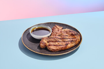 Grilled T-bone beef steak with sauce; a minimalist culinary concept with a surreal summer backdrop