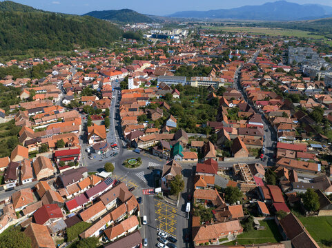 An aerial perspective above the town of Zărnești in Brașov County, Romania, captures a picturesque rural scene.