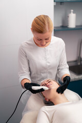 a cosmetologist will perform a face-lifting cosmetic procedure on a client in a beauty salon