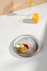 Stylish Breakfast Arrangement with Syrniki, Sour Cream, Fruit Sauce, Orange Juice, and Sparkling Wine.