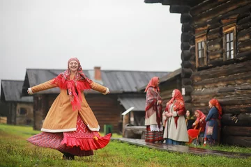 Fototapeten Traditional Slavic rituals in the rustic style. Outdoor in summer. Slavic village farm. Peasants in elegant robes. © alexkich