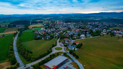Aerial around the village Strasskirchen in Germany on a cloudy day in late summer