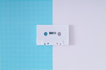 Layout of retro white audio cassette tape on white and blue background. Creative concept of old...