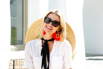 Fototapeta premium Cheerful female in white clothes on resort terrace