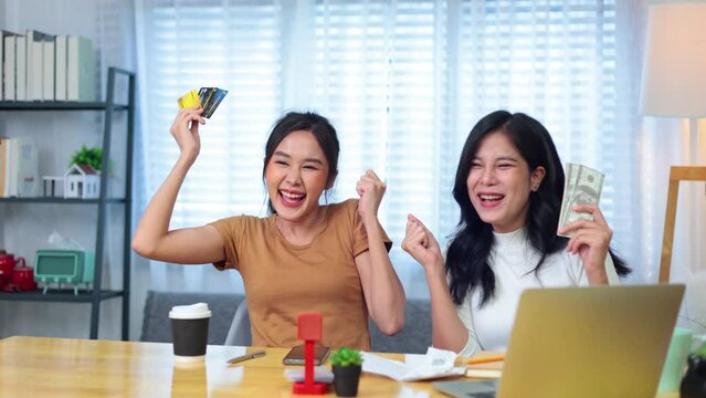 slow motion VDO. Credit cand and. paper Bills payment on female hand. Happy Young woman sitting and calculating household expenses and payment online by credit card on laptop computer