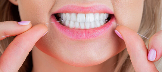 Dental floss. Oral hygiene and health care. Smiling women use dental floss white healthy teeth....
