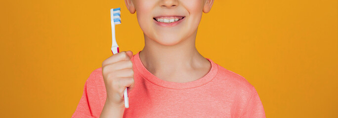 Boy toothbrush white toothpaste. Health care, dental hygiene. Joyful child shows toothbrushes. Little boy cleaning teeth. Dental hygiene. Happy little kid brushing her teeth. Kid boy brushing teeth