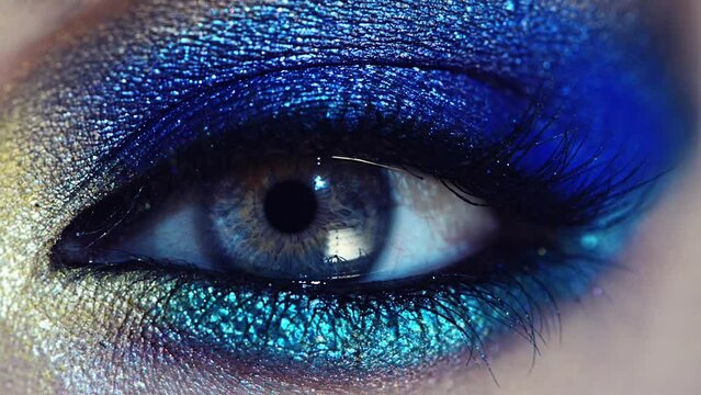 Person, eye makeup and artistic cosmetics or closeup for grooming glamour, party trend or confidence. Beauty, pupil and bold glitter for fashion style or skincare for cyberpunk, disco or creative