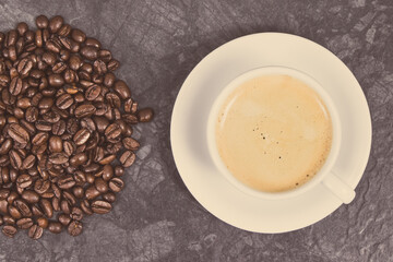 Roasted fragrant coffee grains and coffee with milk. Vintage photo