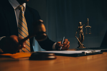 Judge gavel with Justice lawyers having team meeting at law firm background. Concepts of Law and...