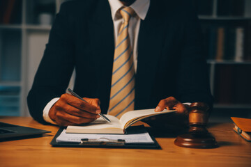 Judge gavel with Justice lawyers having team meeting at law firm background. Concepts of Law and Legal services.