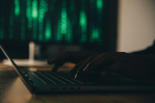 Hacker code in laptop. Cyber security, privacy or hack threat. Coder or programmer writing virus software, malware, internet attack or developing digital design. Green web data in computer screen.