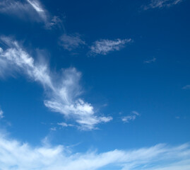 White fluffy clouds in the blue sky.