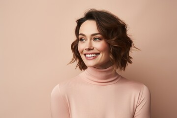 Portrait of a blissful woman in her 30s wearing a classic turtleneck sweater against a pastel or...