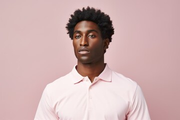 Portrait of a tender afro-american man in his 30s wearing a breathable golf polo against a pastel or soft colors background. AI Generation