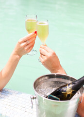 Couple with champagne in the pool