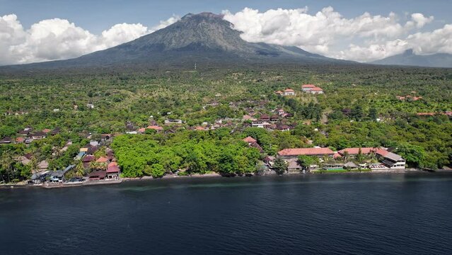 Aerial drone flight near Amed village north Bali with a clear view of the sacred Agung volcano mountain