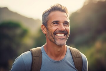 Portrait of a smiling man in his 40s sporting a breathable hiking shirt against a pastel or soft...