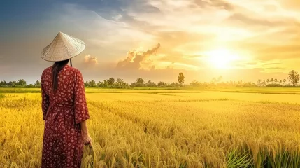 Foto op Canvas Amidst the rice field, an Asian woman stands as a guardian of tradition, her hands gently cradling the harvest that sustains generations © Liaisan