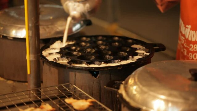 Making coconut pancakes street food at night in Chiang Mai, Thailand