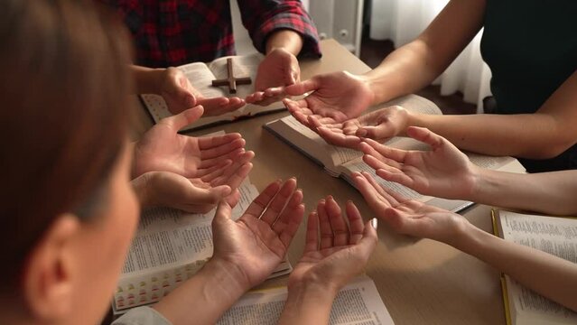 Sense of devotion and spiritual fulfill with christian catholic follower immerse in faith. Slow motion christian people practicing group prayer, holding hand while praying together. Burgeoning