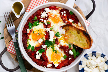 Shakshukka with feta and bread.traditional moroccan dish. selective focus. hugge style