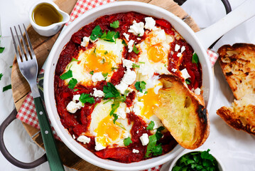 Shakshukka with feta and bread.traditional moroccan dish. selective focus. hugge style