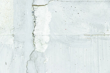 White concrete wall has cracks. use as texture and background vintage style.