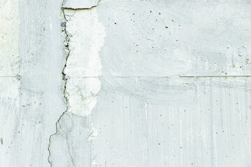 White concrete wall has cracks. use as texture and background vintage style.