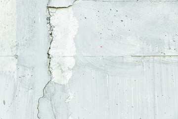 White concrete wall has cracks. use as texture and background vintage style.