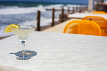 Cocktail glasses on sea background
